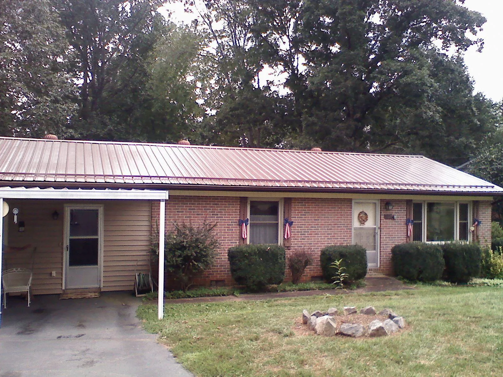 Bronze metal roof and carport on a brick ranch home — Roof Repair work by our crew in Bolingbrook